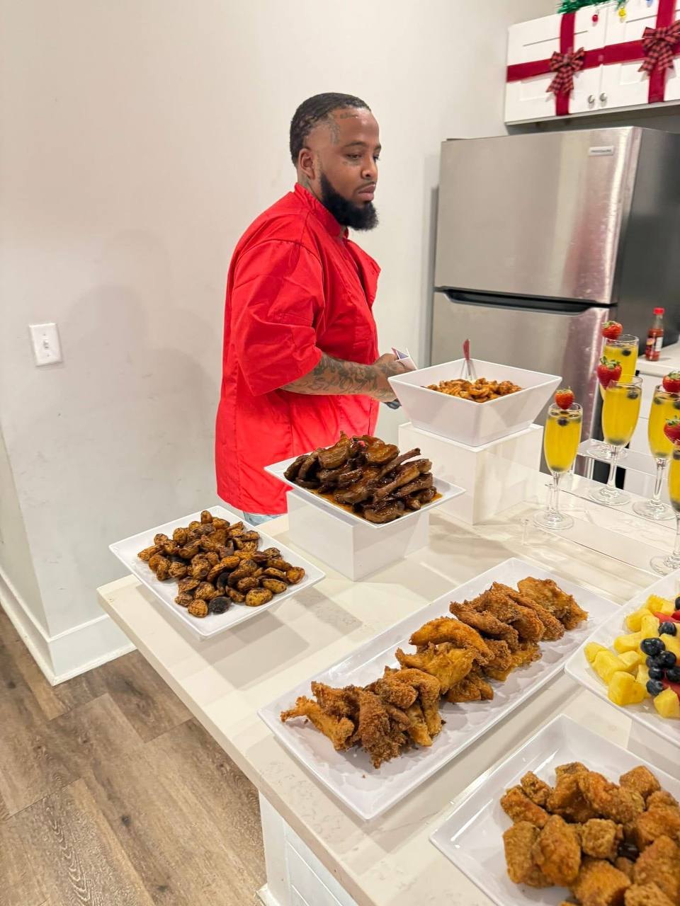 Chef Inkky plating a catering spread